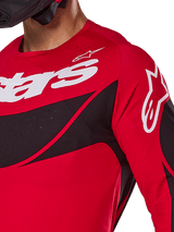 Alpinestars 2025 Techstar Dreem Jersey, Motocross Jersey, Bright Red and Black, close-up view of chest and shoulder featuring white branding, black diagonal panels with laser-cut perforations for ventilation, athletic racing fit for off-road performance.