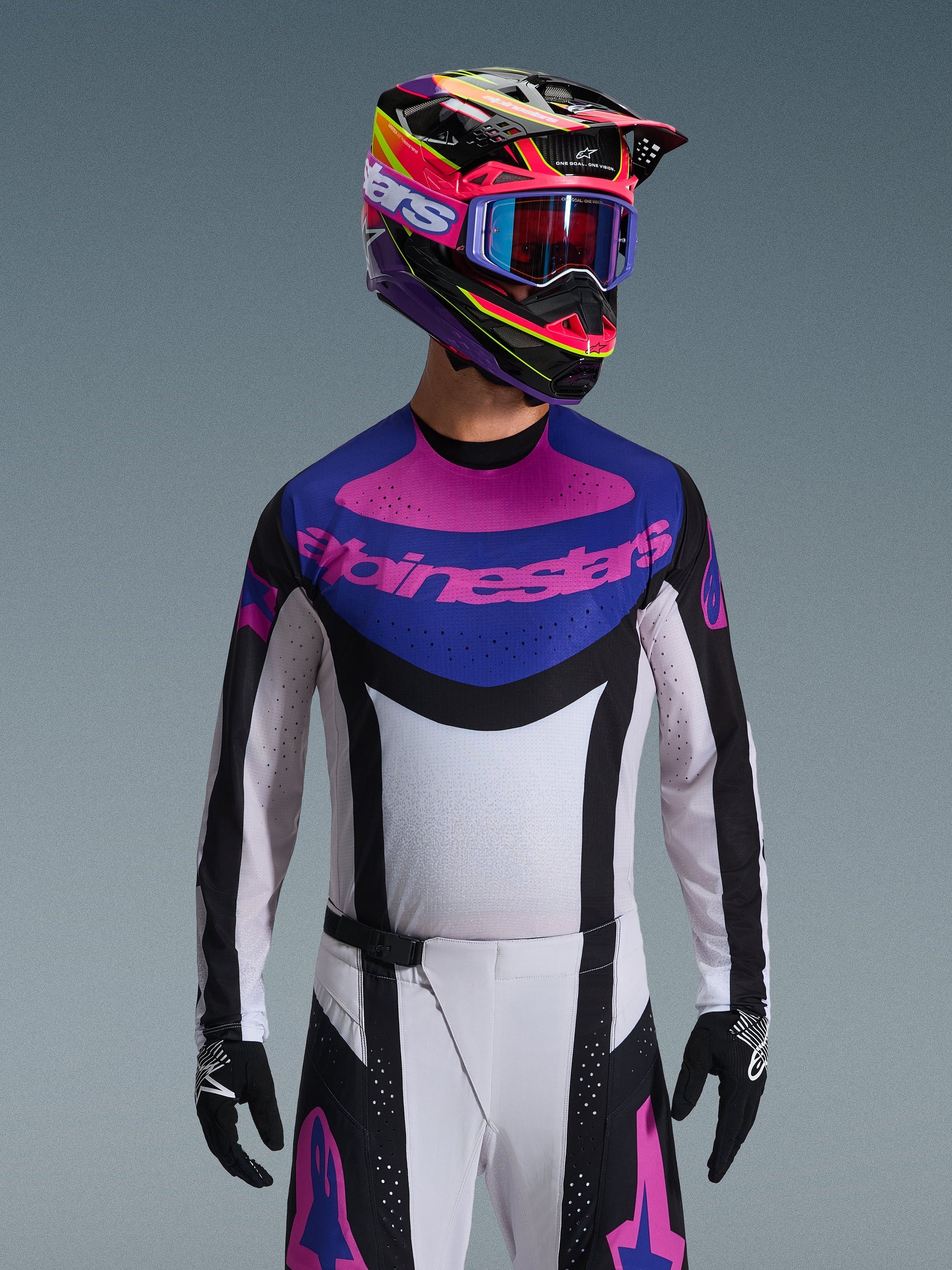 Alpinestars 2026 Techstar Knif Jersey, Motocross Jersey, Black Light Gray and Purple, pink Alpinestars logo on the chest, worn with matching colorful helmet and motocross pants, athletic race fit with laser-cut perforations for ventilation