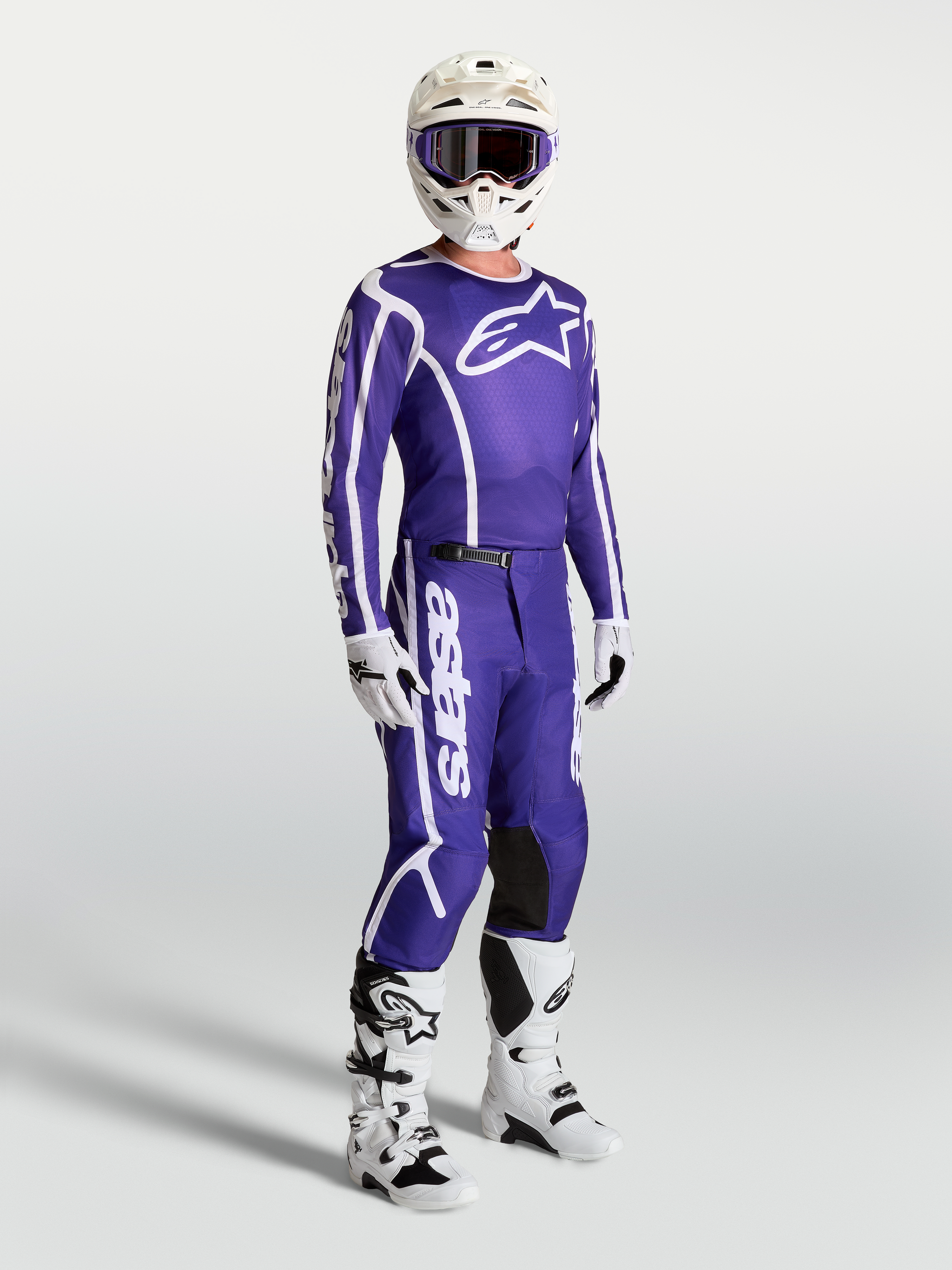 Alpinestars Fluid Apex V2 Jersey and matching pants, Deep Blue and White motocross gear set on-model with white boots and helmet.