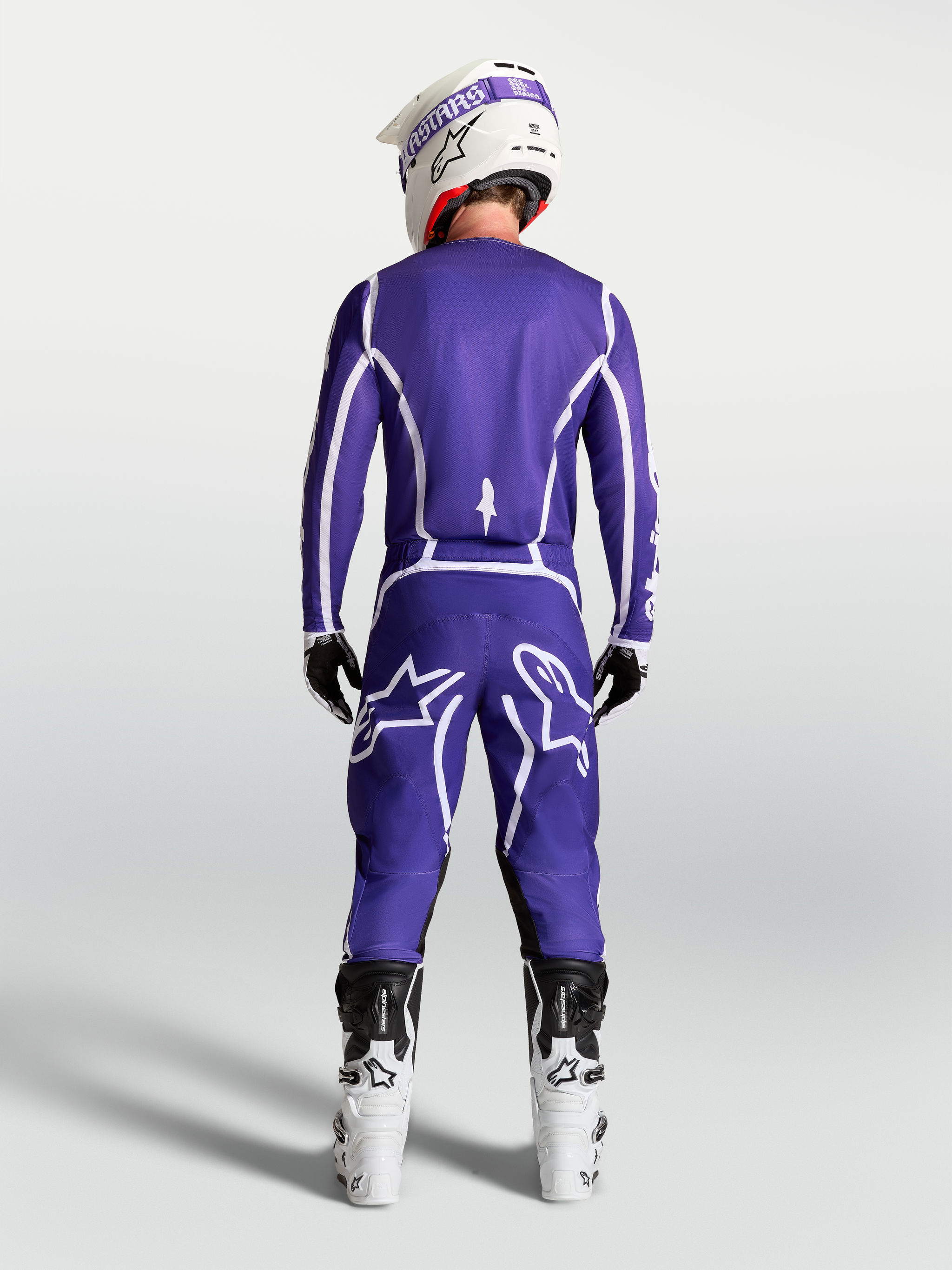 Alpinestars Fluid Apex V2 Jersey in Deep Blue and White, rear view on rider with matching motocross pants and white boots.