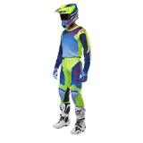 Alpinestars 2024 Racer Hoen Jersey, Motocross Jersey, Yellow Fluo and Blue Night Navy, worn by a rider with matching pants, helmet, and white boots, professional racing gear for off-road riding