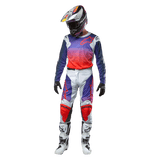 Motocross rider wearing complete racing gear, Alpinestars 2024 Racer Hoen Jersey with purple to hot orange gradient and light gray shoulders, matching light gray pants with red and purple accents, coordinated helmet and white boots, full off-road racing outfit