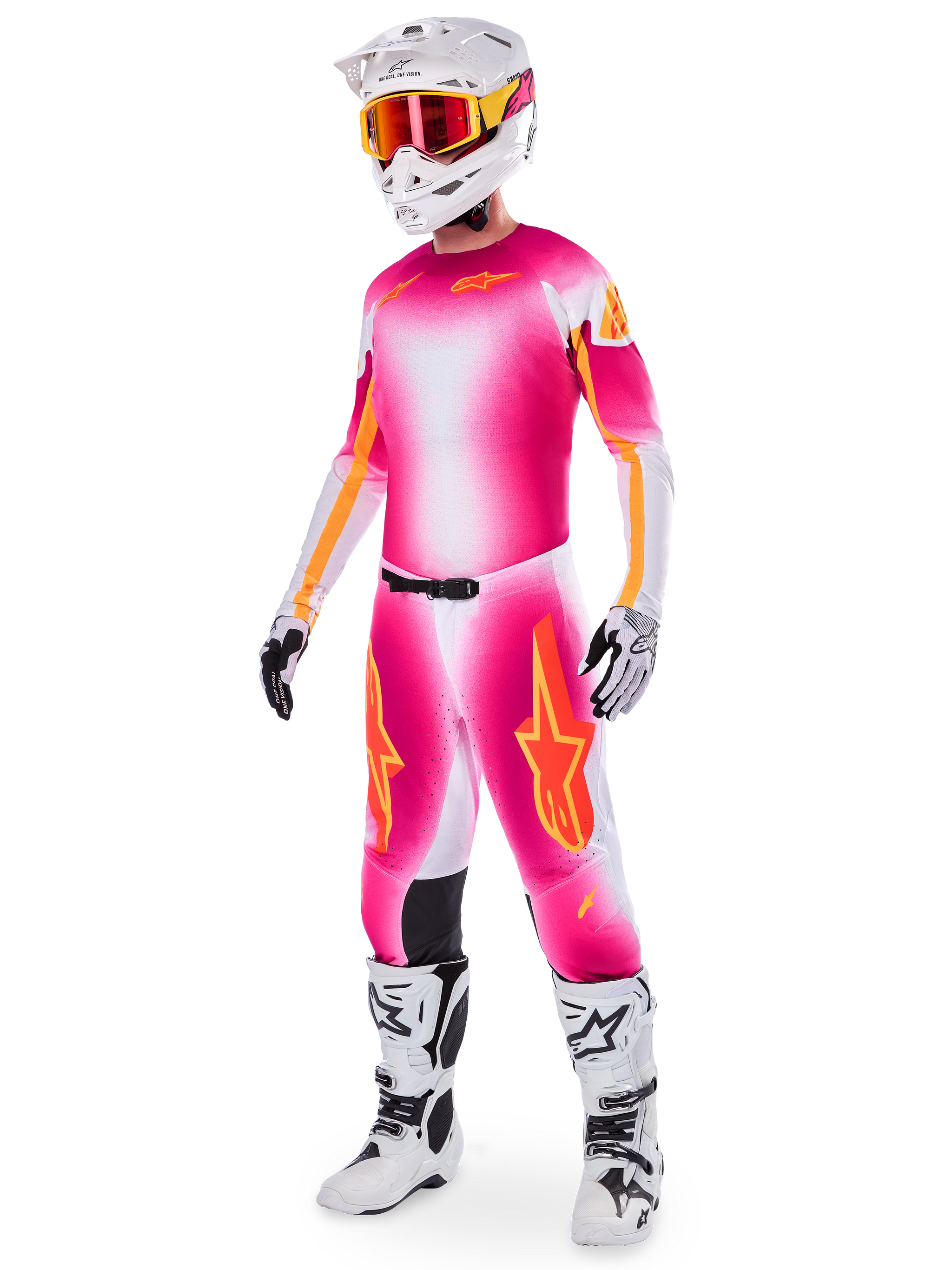 Motocross rider wearing the Limited Edition Supertech AFD MIG Jersey and matching pants, Pink Fluo and White with orange branding, paired with a white helmet, red goggles, and white boots, complete professional off-road racing gear
