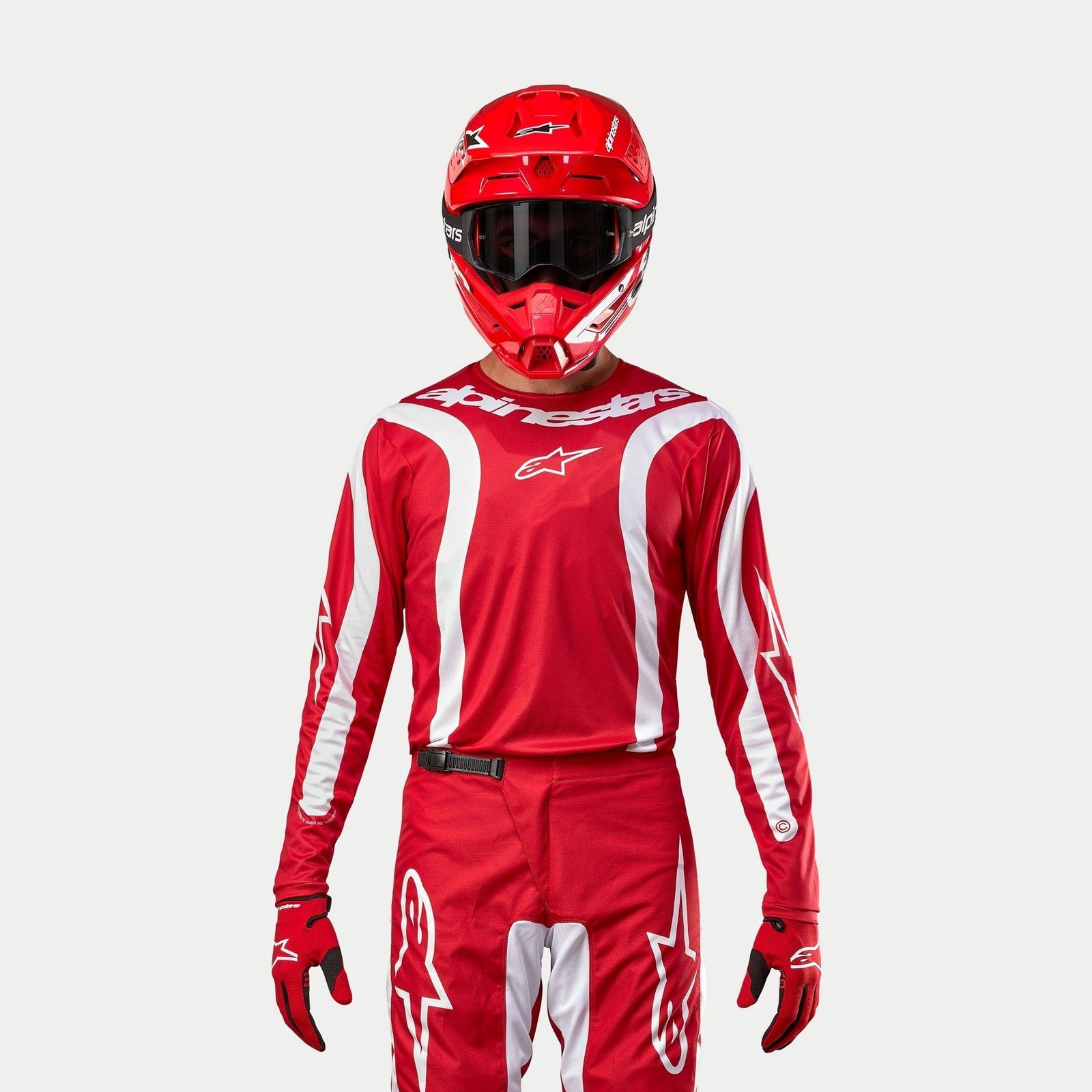 Alpinestars 2024 Fluid Lurv Jersey, Motocross Jersey, Mars Red and White, worn with matching red pants, helmet, and gloves, featuring white graphic accents on the sleeves and bold chest branding, athletic fit for off-road racing