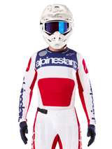 Limited Edition Techstar Fortitude Jersey, Motocross Racing Jersey, White Red and Blue, worn with matching pants and helmet, featuring Alpinestars branding and One Goal One Vision motto, perforated details, sleek design for off-road performance