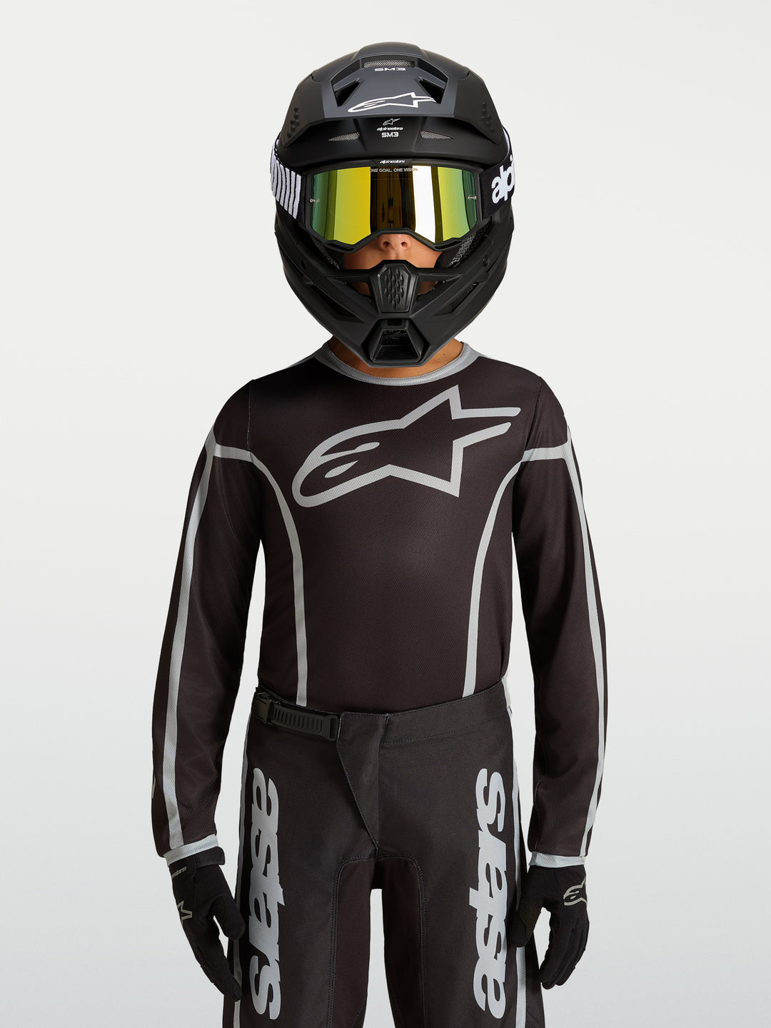 Alpinestars Youth Fluid Apex V2 Jersey, Black and Silver motocross gear, ergonomic athletic fit with moisture-wicking polyfabric.