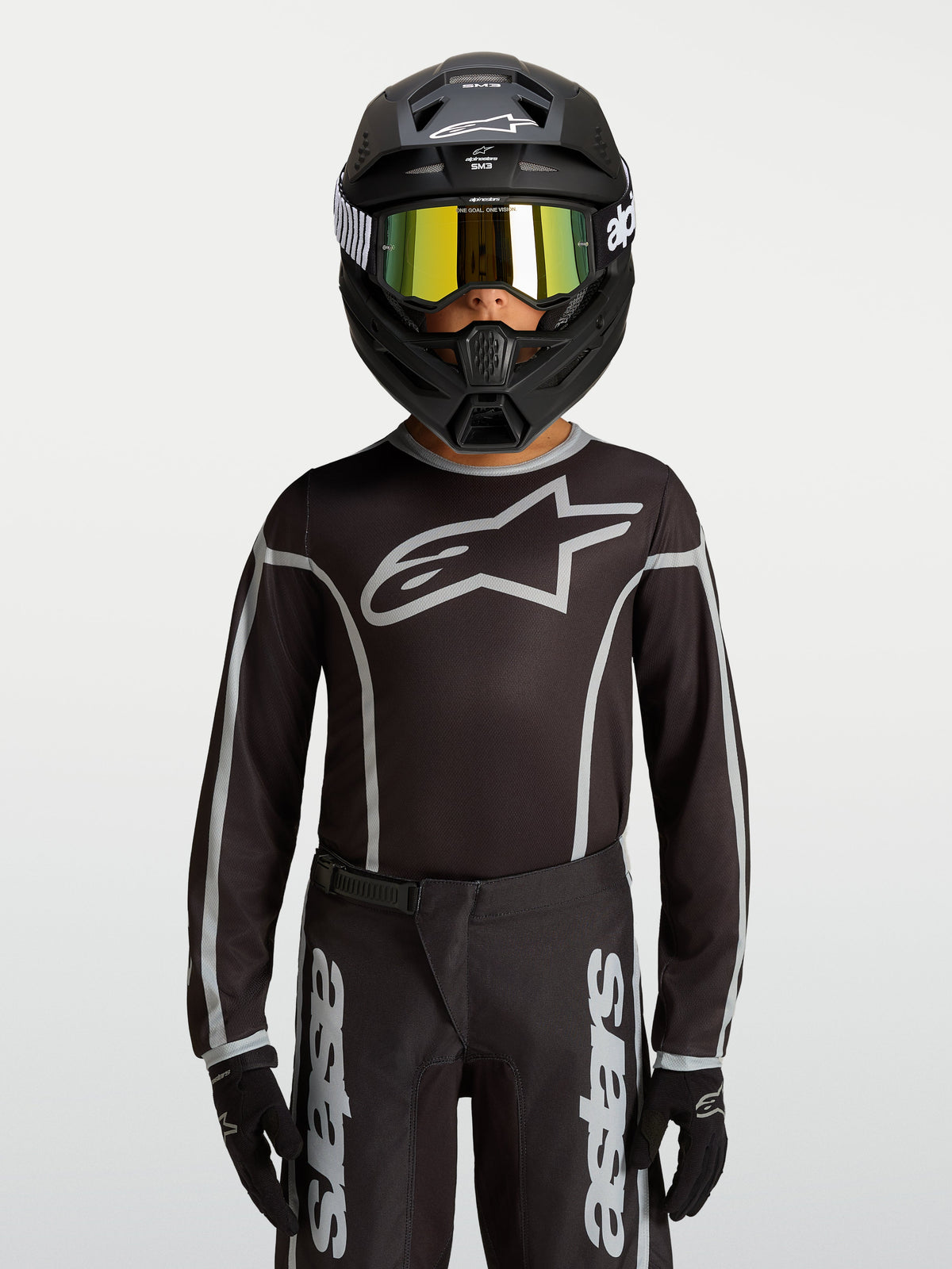 Alpinestars Youth Fluid Apex V2 Jersey, Black and Silver motocross gear, ergonomic athletic fit with moisture-wicking polyfabric.