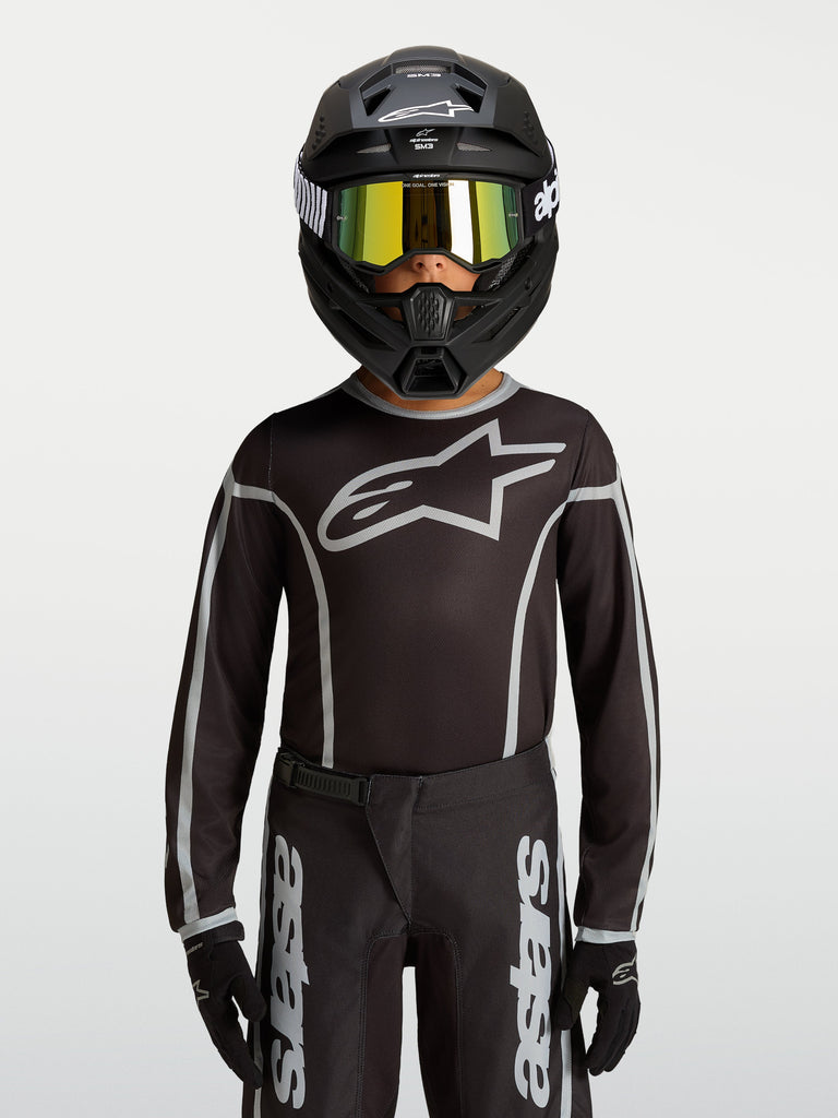 Alpinestars Youth Fluid Apex V2 Jersey, Black and Silver motocross gear, ergonomic athletic fit with moisture-wicking polyfabric.