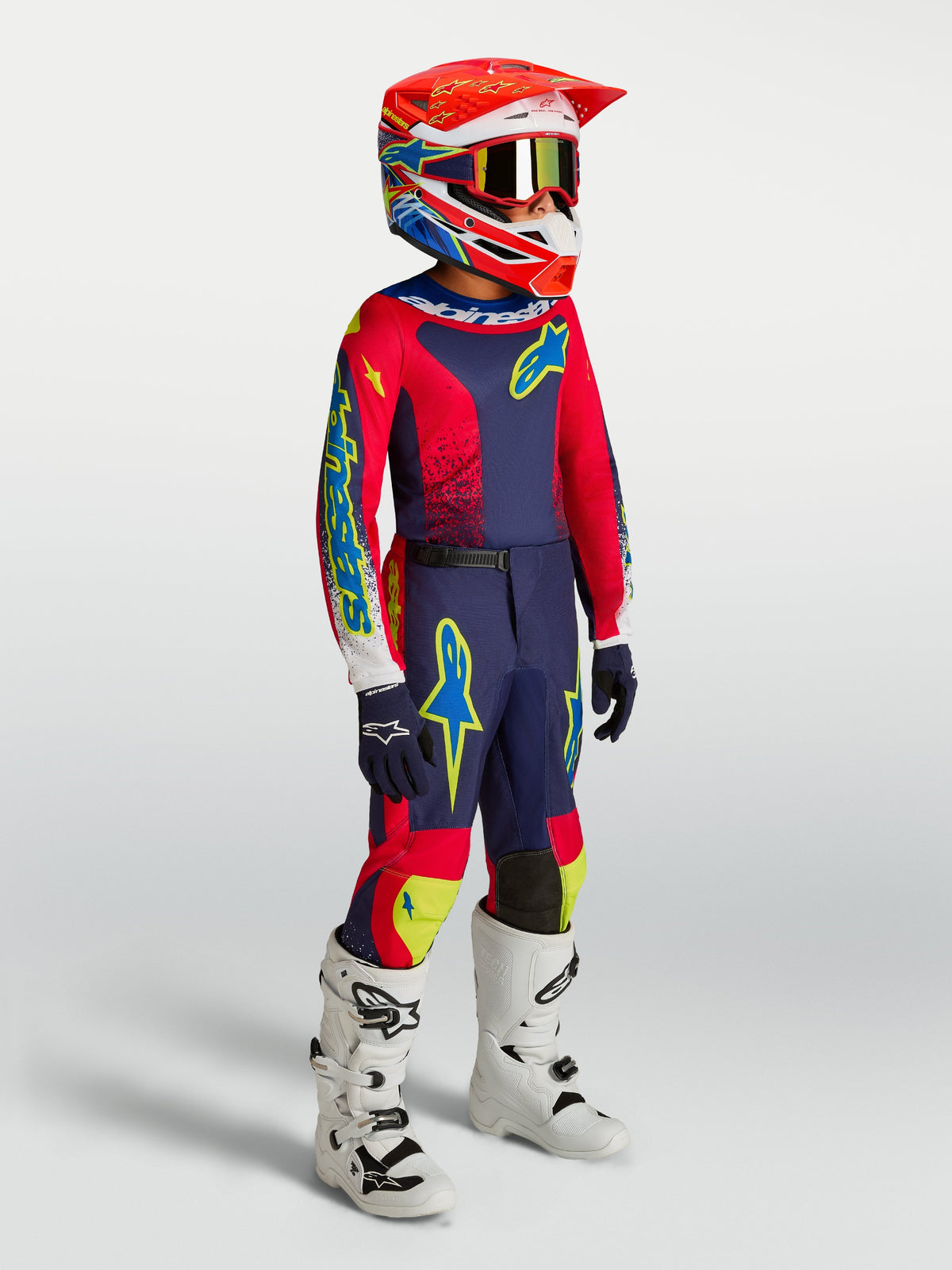 Alpinestars 2027 Youth Fluid Drag Gear Set, kids motocross racing kit in Blue Navy and Fire Red with white boots.