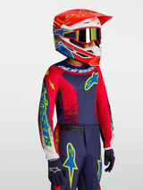 Alpinestars Youth Fluid Drag Jersey, youth motocross gear in Navy Blue and Fire Red with a matching racing helmet.