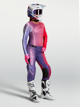Alpinestars Stella Fluid Kepler Jersey, women's motocross top in Purple and Rouge Red, worn with matching pants and white boots.