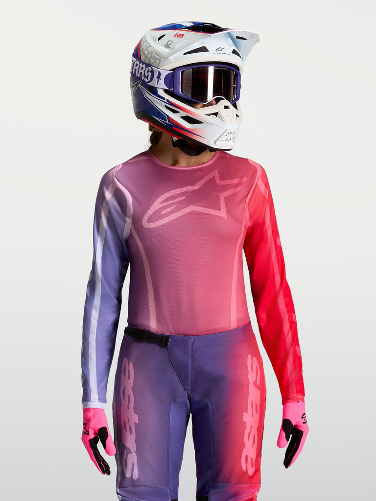 Alpinestars Stella Fluid Kepler Jersey, women's motocross racing top in purple and rouge red, featuring a moisture-wicking polyfabric construction with an athletic fit, paired with a matching helmet and gloves.