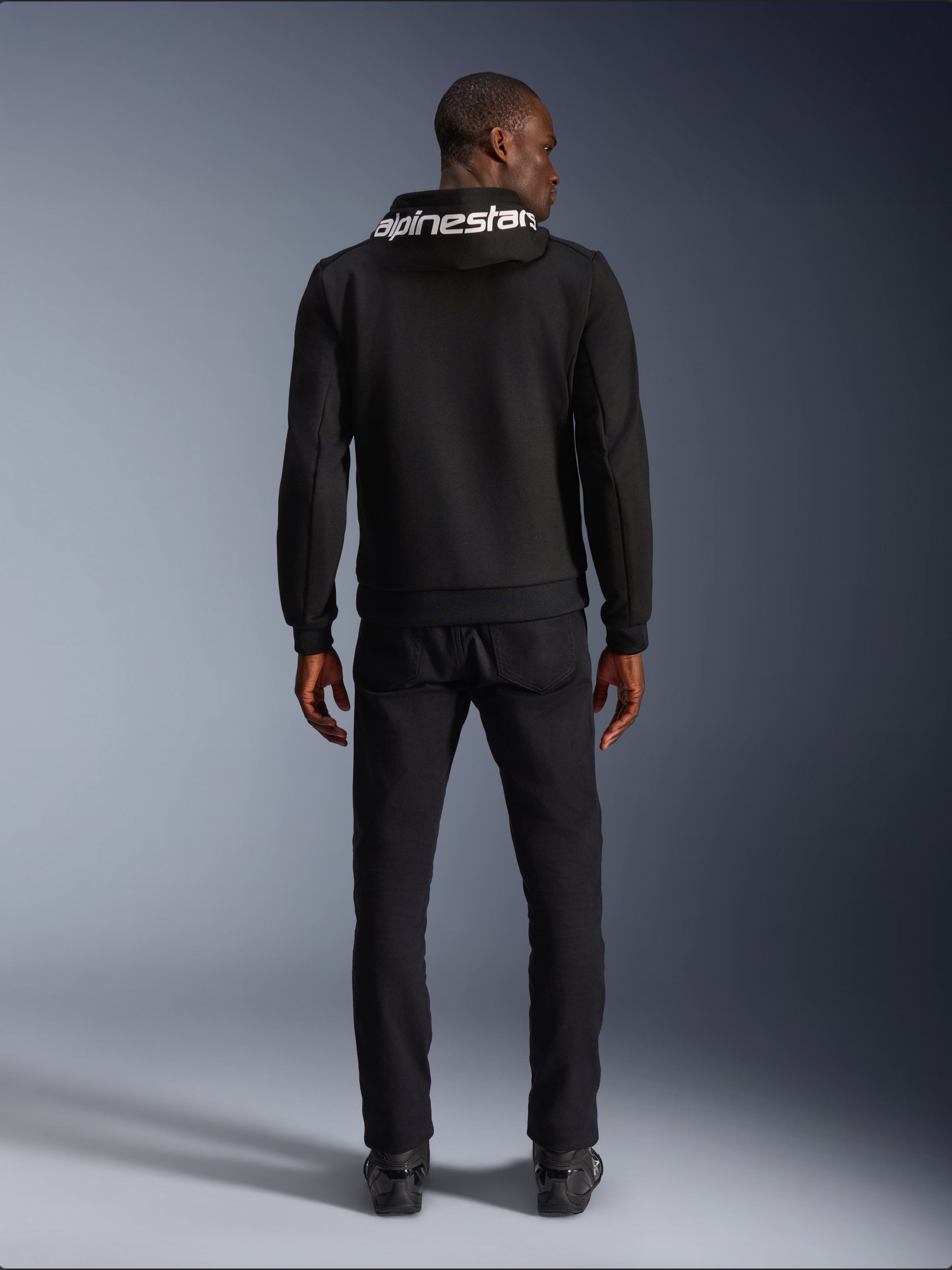 Alpinestars Chrome V2 Sport Hoodie, black tech fleece motorcycle hoodie with white hood logo, rear view on model.