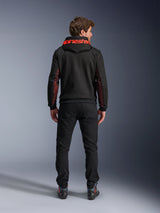 Alpinestars Chrome Air Sport Hoodie, Black and Red Fluo, back view of man wearing casual motorcycle jacket, featuring red Alpinestars branding on the hood and red mesh panels on the sleeves, paired with black pants.