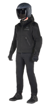 Alpinestars Moflow Air Tech Hoodie, Urban Motorcycle Hoodie, Black Black, worn by a rider with a matte black helmet, black gloves, and riding pants, featuring a full mesh construction for airflow, zippered pockets, and subtle chest logos, sleek casual design for warm weather street riding.