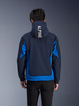 Alpinestars Radium Tech Hoodie, Night Navy and Royal Blue motorcycle jacket, back view showing white 'ALPINE' branding on the hood, urban performance gear with athletic fit and contrasting color panels