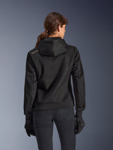 Alpinestars Stella Chrome Superairflow Hoodie, back view of woman wearing black technical 3D mesh motorcycle hoodie, features engineered hood and copper logo on shoulder, worn with black motorcycle gloves and pants.