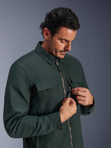 Alpinestars Bryon WR Overshirt in Dark Emerald, urban motorcycle jacket, worn by a man demonstrating the vertical zippered chest pocket and cargo pockets, featuring a durable waxed canvas texture and workwear-inspired design.