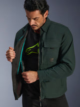 Alpinestars Bryon Water Resistant Overshirt, Dark Emerald, lifestyle view of model revealing the interior thermal vest and teal zipper detail, urban motorcycle jacket with waxed canvas and cargo pockets