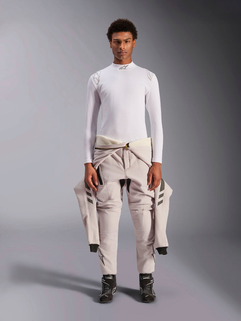 Alpinestars ZX Evo V3 Top, Long Sleeve, White, auto racing base layer worn with a light-colored racing suit tied around the waist and black racing boots, featuring a mock neck with logo and shoulder branding, professional flame-resistant motorsport underwear