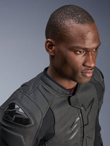 Close-up of a model wearing the Alpinestars Dusk Airflow Leather Jacket, Black on Black, featuring extensive perforated leather for breathability, external DFS shoulder sliders, and a sleek modern design for sport riding.