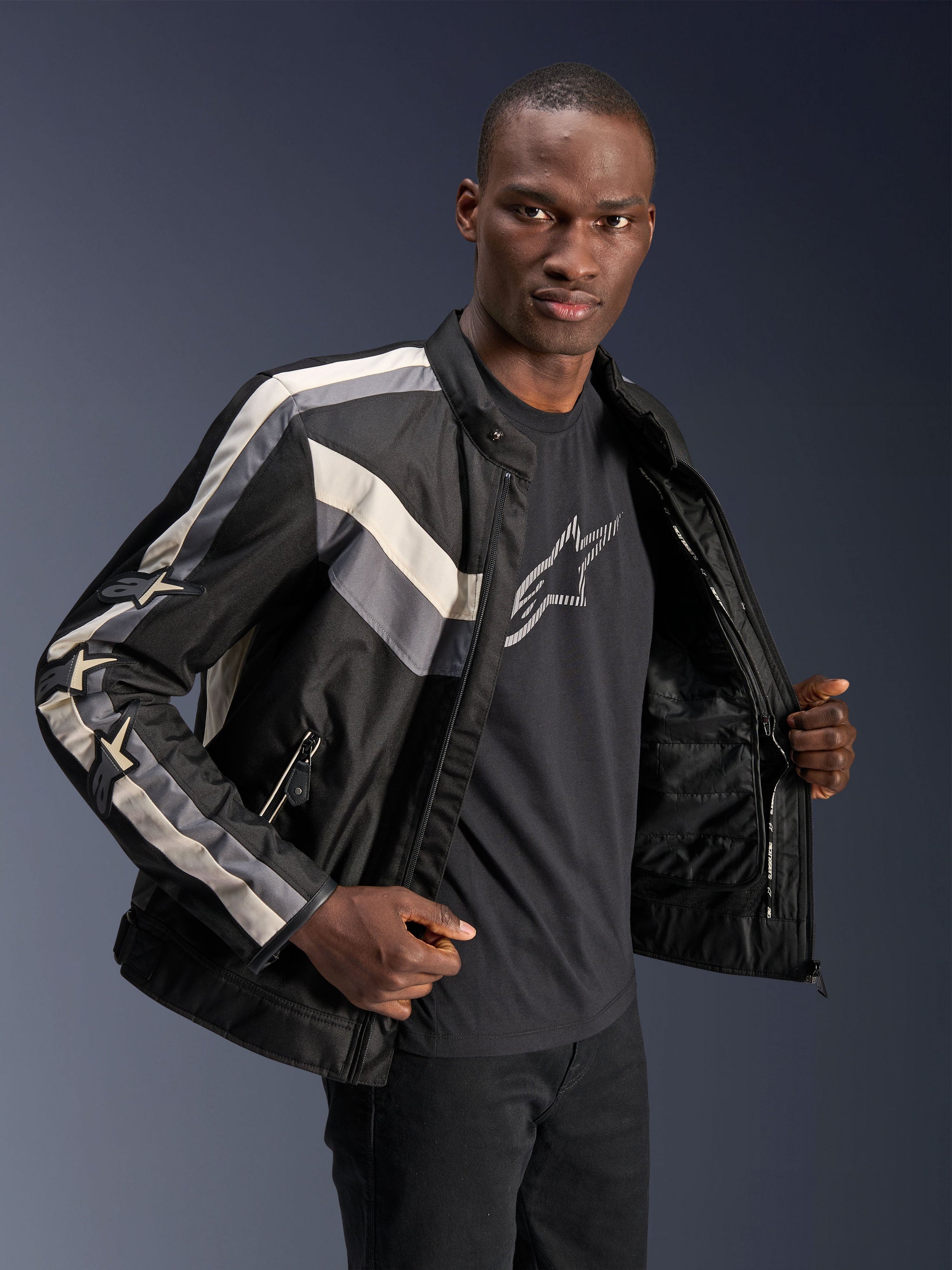 Alpinestars T-Dyno WR Jacket, Black Dark Gray and Ecru, textile motorcycle jacket with vintage-inspired biker fit, stripe details on chest and sleeves, worn over a black graphic tee, urban riding gear
