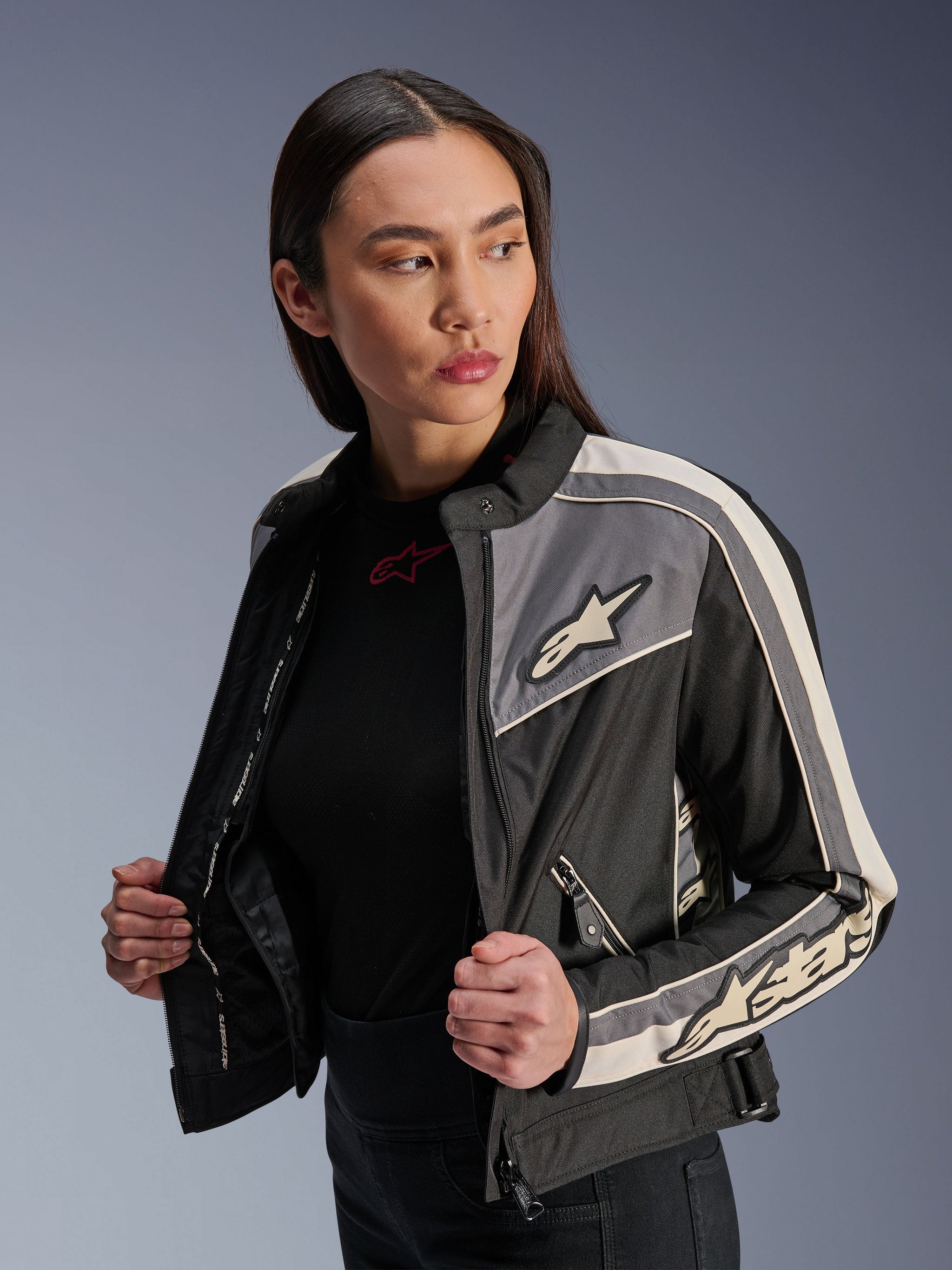 Alpinestars Woman Stella T-Dyno WR Jacket, textile motorcycle jacket, Black Dark Gray and Ecru, vintage-inspired design with sporty stripes and logos on chest and sleeves, worn by a model, urban road riding gear