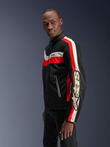 Male model wearing the Alpinestars T-Dyno Air Jacket in Black, Bright Red, and Ecru, vintage-inspired textile motorcycle jacket featuring 3D mesh panels, bold red and off-white stripes, and prominent Alpinestars branding on the sleeve.