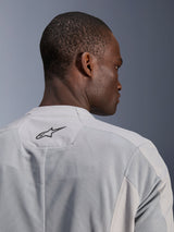 Alpinestars C-1 Air Jacket, Silver Gray Textile Motorcycle Jacket, close-up view from the back featuring tech mesh panels for airflow and a black Alpinestars logo on the upper back, urban rider aesthetic