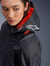 Alpinestars Molly Air Jacket, women's motorcycle jacket, Black and Fluo Coral, close-up of shoulder highlighting the Nucleon Flex protector compartment and white Astars logo on the hood, urban riding gear with ripstop fabric