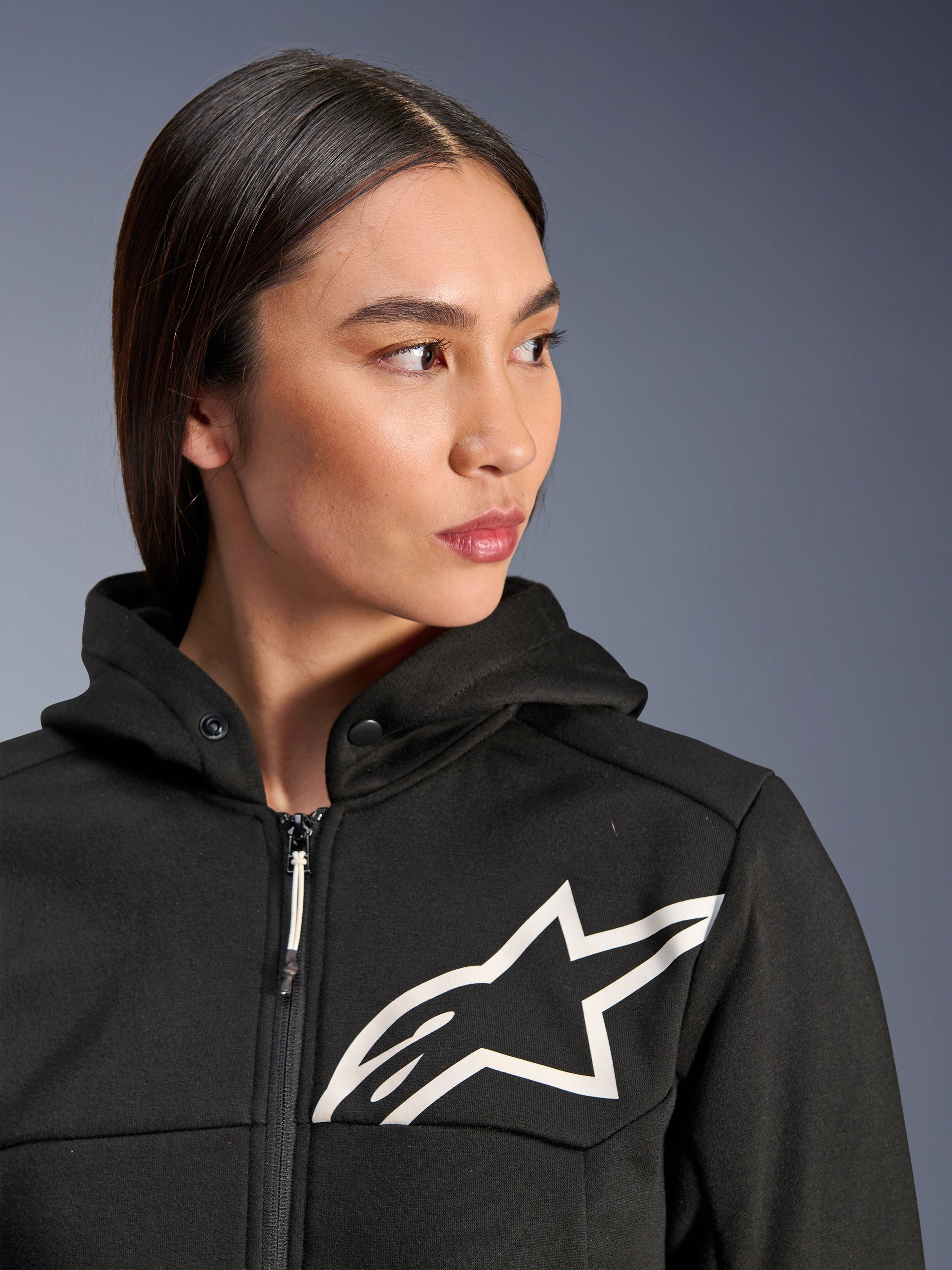 Alpinestars Stella Chrome V2 Sport Hoodie, Black with white Astars logo, women's motorcycle hoodie, tech fleece material, featuring a zippered front and snap-button hood collar, casual urban riding gear
