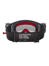 Alpinestars Supertech Corp Goggles Roll Off, Black and Grey with Red accents, rear view showing wide strap with 'ALPINESTARS ONE GOAL. ONE VISION.' white text, integrated roll-off canisters on sides, and red multi-layer face foam, professional motocross eye protection