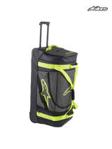 Alpinestars Komodo Travel Bag, rolling gear bag for motorsports and travel, black and anthracite with yellow fluo accents, featuring a retractable handle, durable wheels, and functional compartments for gear stowing
