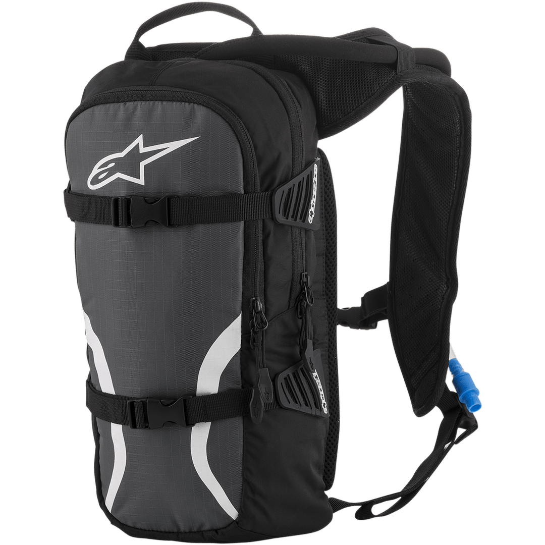 Alpinestars Iguana Hydration Backpack, Off-Road Hydration Pack, Black Anthracite and White, featuring padded mesh shoulder straps, front compression straps with buckles, zippered compartments, and a blue hydration tube with nozzle