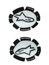 Alpinestars GP Plus Knee Sliders, White and Black, Motorcycle Racing Knee Protectors, pair showing left and right sliders with white plastic surfaces and black Astars logos, scalloped black Velcro backing featuring 'ONE GOAL' and 'ONE VISION' branding