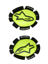 Alpinestars GP Plus Knee Slider, Motorcycle Racing Knee Sliders, Yellow Fluo and Black, left and right pair featuring a black star logo on a glossy yellow surface, textured black edges with "alpinestars" and "ONE GOAL ONE VISION" branding, designed for track abrasion