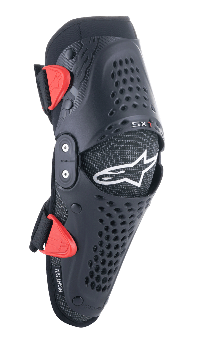Alpinestars Youth SX-1 Knee Protectors, Motocross Knee Guards, Black and Red, featuring perforated ventilation holes, dual-pivot hinge system, adjustable straps with red buckles, white star logo, youth off-road motorcycle protection