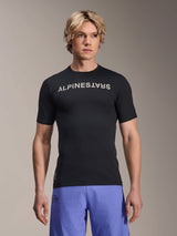 Alpinestars A-Aria Switch Jersey, Short Sleeve MTB Jersey, Black with white Alpinestars wordmark on chest, worn by male model with purple shorts, lightweight performance fabric for trail riding