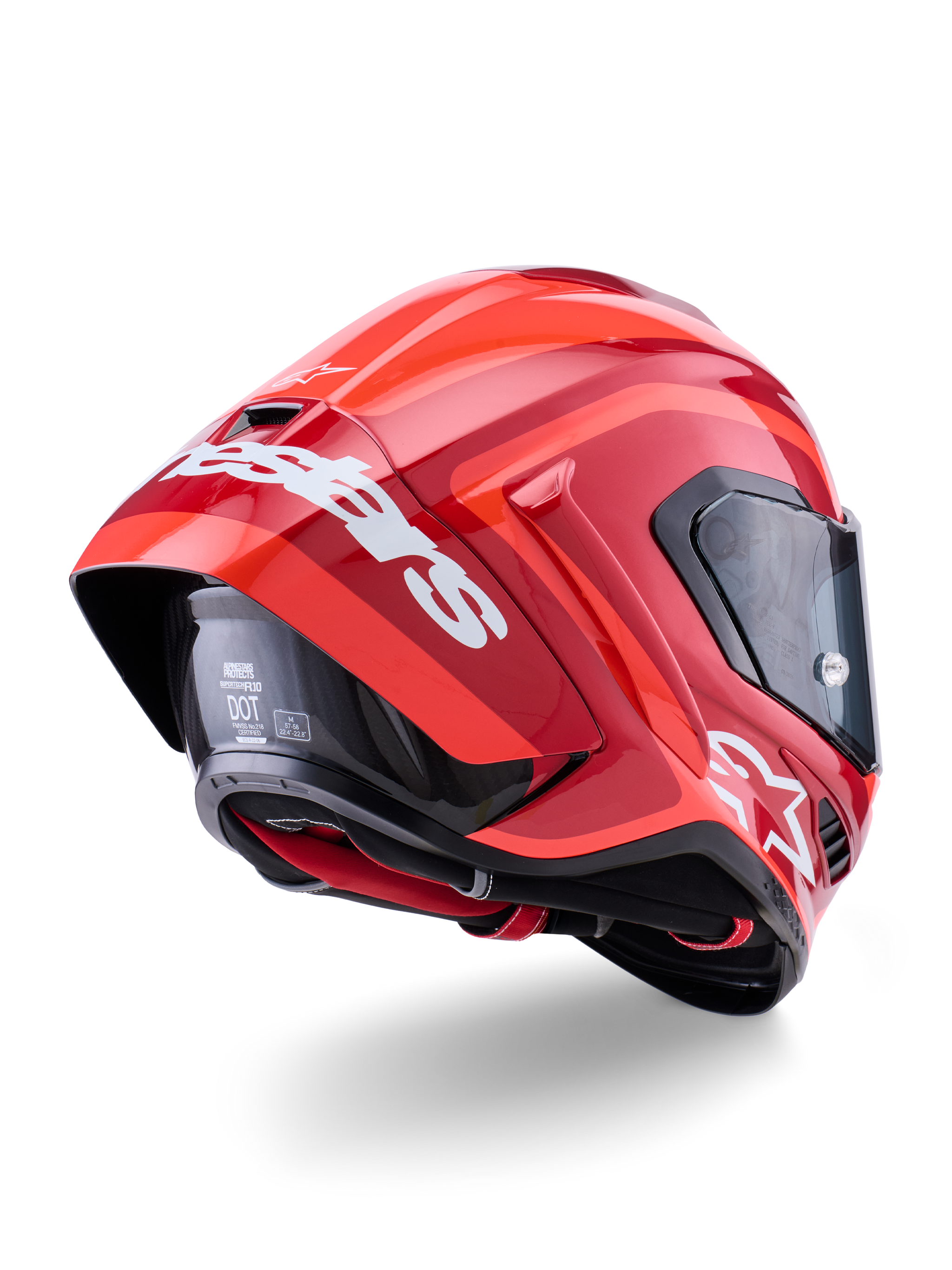 Alpinestars Supertech R10 Arius Helmet, Glossy Red with white branding, Rear three-quarter view showing aerodynamic spoiler, carbon fiber shell construction, and sleek racing profile with a dark visor