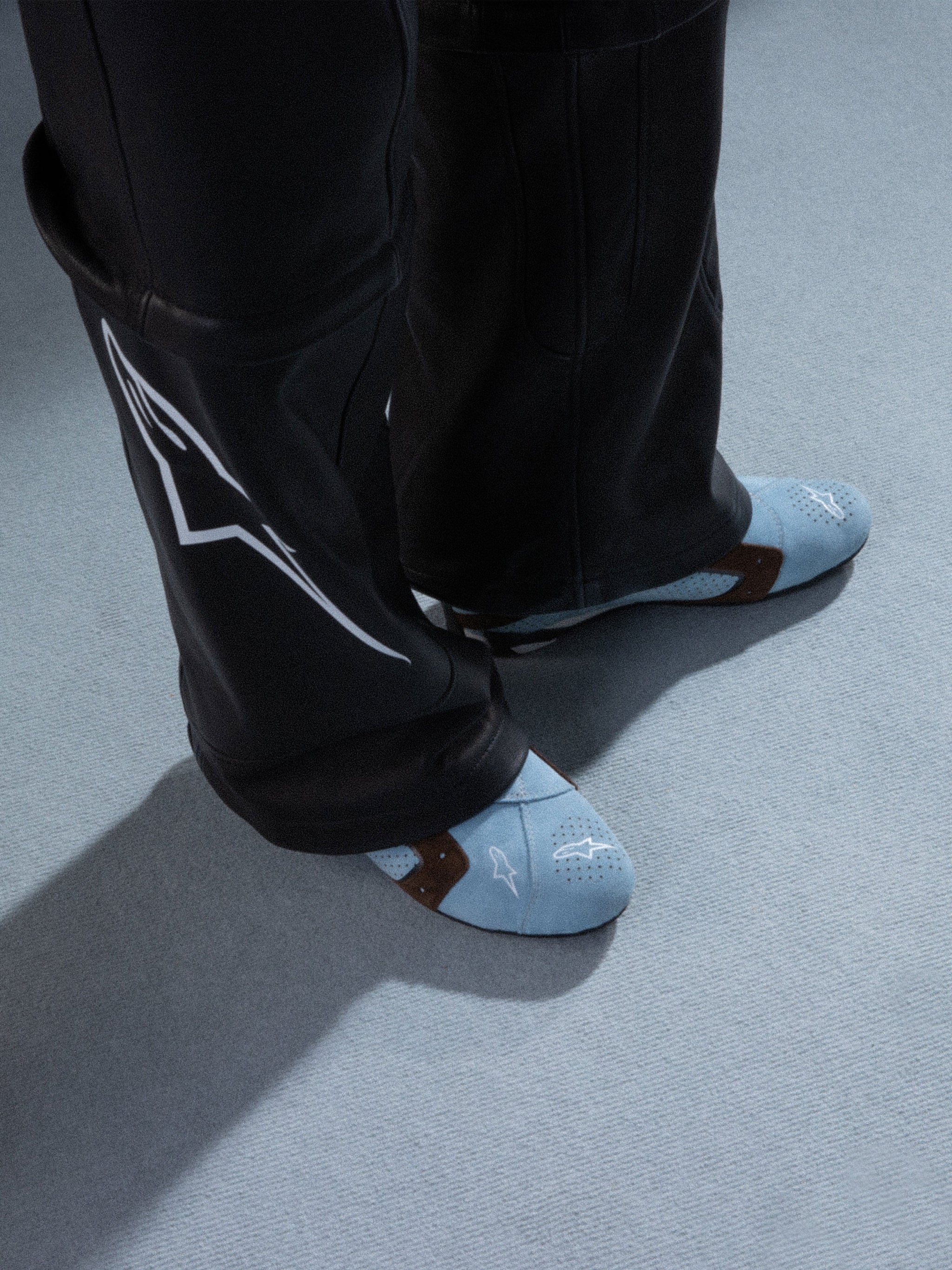 Alpinestars RSRV Starline Shoes, Light Blue Perforated Sneakers with Brown Straps, Casual Lifestyle Footwear, White Logo Detail, Worn with Black Leather Pants