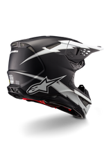 Alpinestars Supertech M10 Ampress Helmet, Motocross Helmet, Black and White Matte, featuring bold white lightning bolt graphics on a matte black shell, rear three-quarter view showing Alpinestars branding and ventilation ports