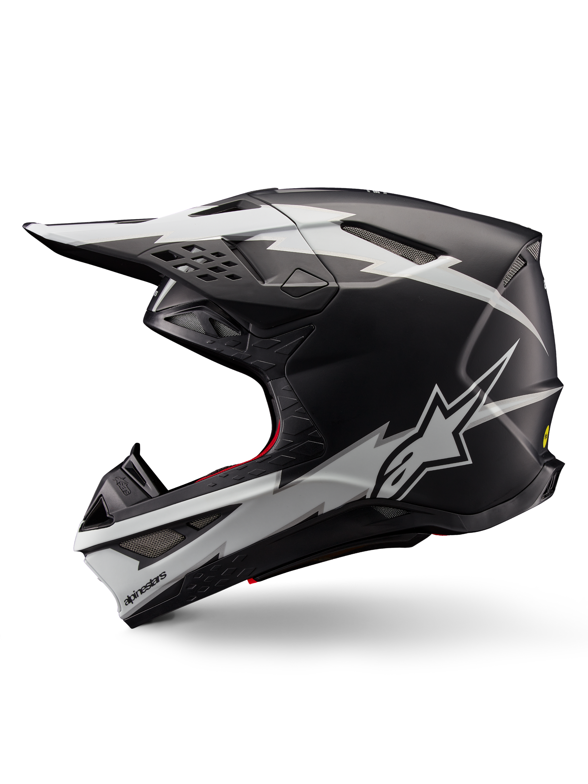 Alpinestars Supertech M10 Ampress Helmet, Motocross Helmet, Matte Black and White, profile view featuring bold white lightning-style graphics, aerodynamic shell with visible ventilation ports and visor, advanced off-road protection