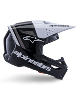 Alpinestars S-M3 Radium Helmet, Motocross Off-Road Helmet, Black White and Gray Glossy, featuring an angular aerodynamic design with ventilation ports, side profile view, glossy finish with gray stripes, and a white visor with Alpinestars branding