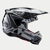 Alpinestars S-M5 Rover 2 Helmet ECE, Motocross Helmet, Black and Silver Glossy, side profile view with a camouflage-style pattern, featuring an aerodynamic visor, multiple air vents, and the white Astars logo on the side.