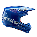 Alpinestars S-M5 Corp Helmet ECE, Blue Glossy motocross helmet, side profile view, bold white Alpinestars branding across the side, purple accents in ventilation ports, lightweight aerodynamic shell for off-road performance