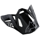 Alpinestars S-M8 Helmet Visor Radium, Glossy Black motorcycle helmet peak with gray Alpinestars logo, featuring aerodynamic angular cutouts and sharp edges, modern racing style for off-road helmets