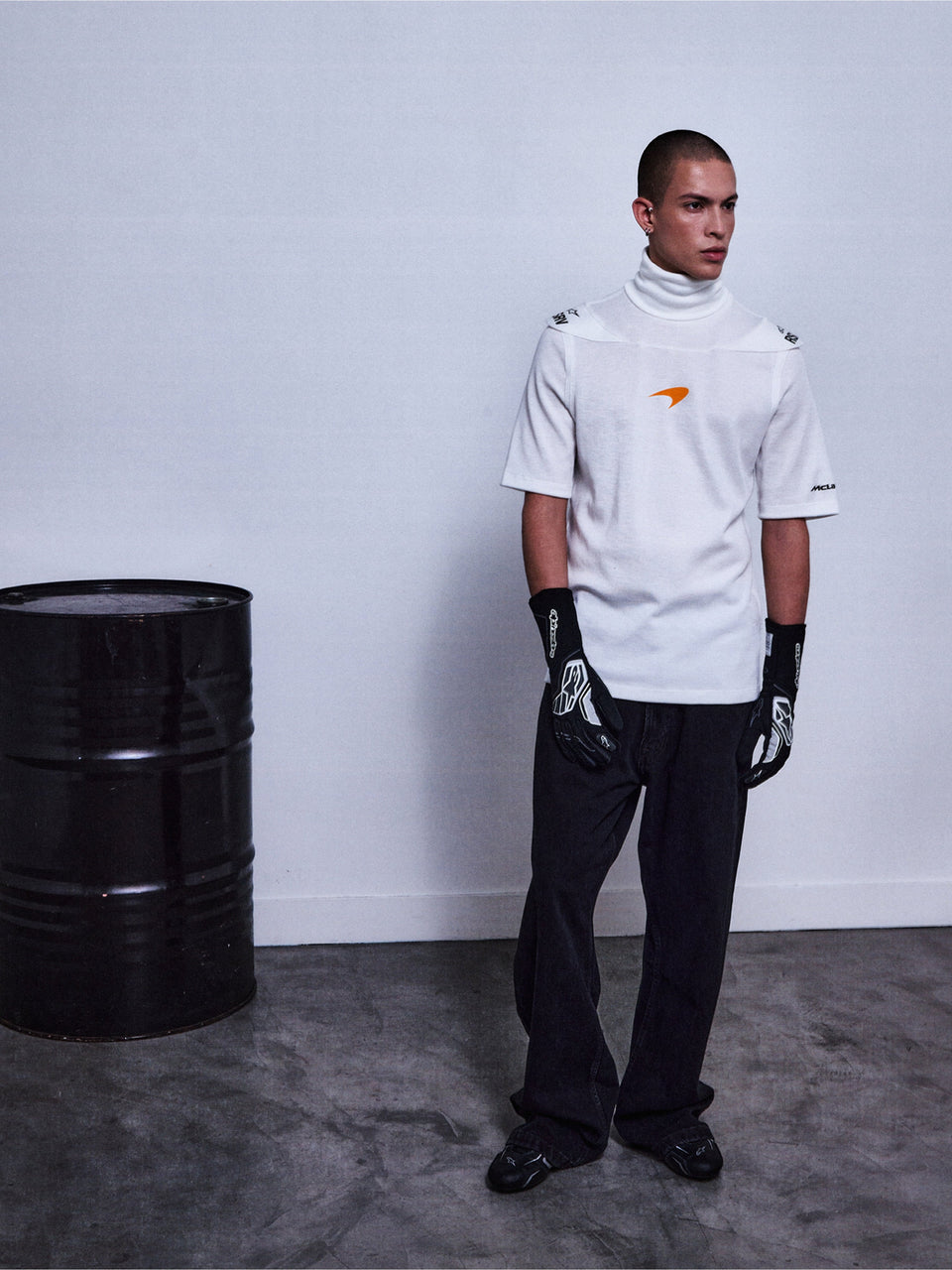 RSRV Pyro SS Tee, White Short Sleeve Turtleneck with Orange Logo, Lifestyle Streetwear, Premium Cotton Construction, Styled with Black Pants and Patterned Gloves