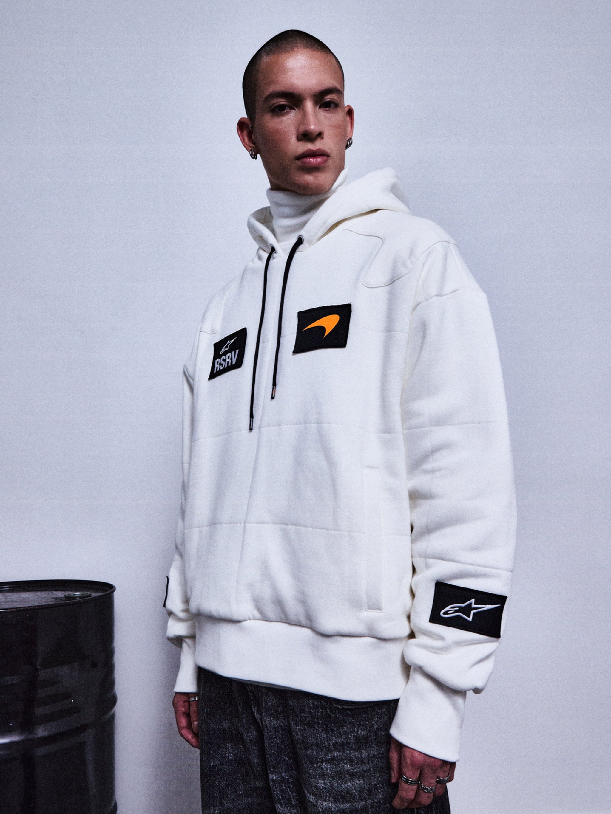 RSRV Rival Hoodie, White Lifestyle Hoodie, Unisex, with Black Patches and Orange Logo Detail, Premium Streetwear, worn with Dark Gray Pants