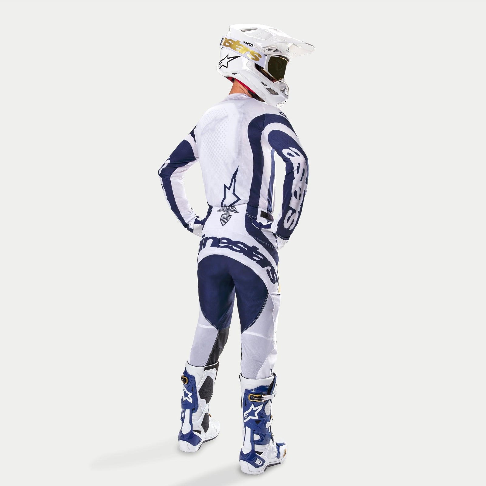 Alpinestars Techstar Dress Whites Tropical LE motocross pants and jersey, white and dark blue, rear three-quarter view.