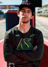 Alpinestars Ayess Csf Tee, Long Sleeve T-Shirt, Black, featuring green and yellow gradient AS graphics on the chest and sleeves, casual motorsport-inspired streetwear worn at a racetrack
